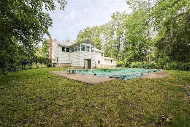 286 Mountain St, Sharon, MA 02067 - rear view of property featuring a covered pool, a chimney, a patio, and a lawn