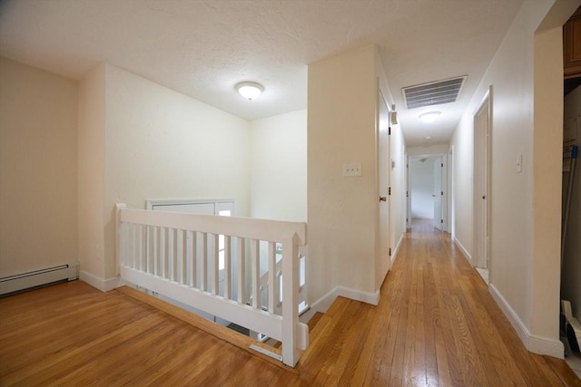 286 Mountain St, Sharon, MA 02067 - corridor featuring an upstairs landing, light wood-style flooring, and a baseboard radiator