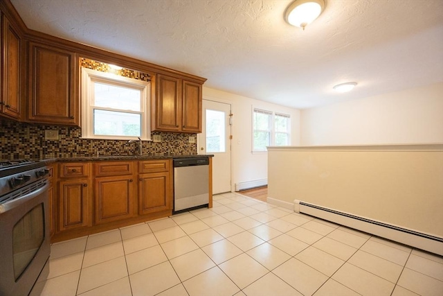 286 Mountain St, Sharon, MA 02067 - kitchen with appliances with stainless steel finishes, a baseboard heating unit, backsplash, and a baseboard radiator