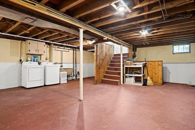 below grade area with washing machine and clothes dryer and stairs