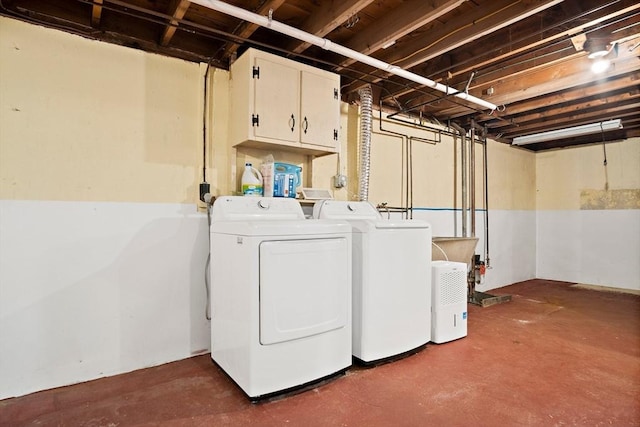 washroom with washer and dryer and cabinet space
