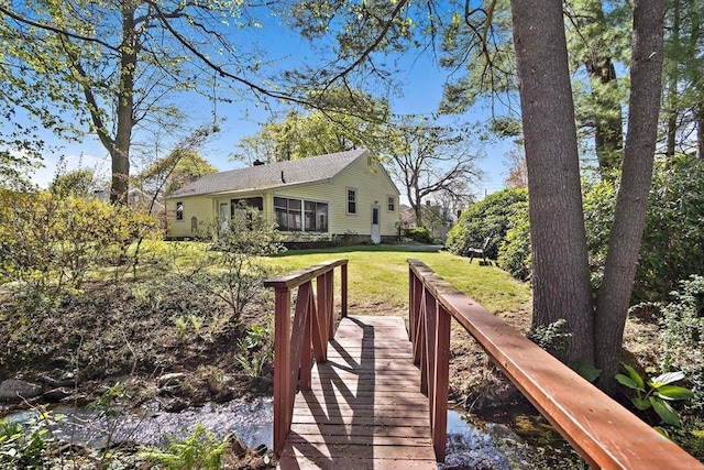 back of property featuring a yard