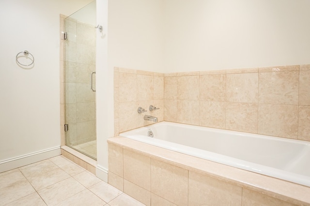 bathroom with separate shower and tub and tile patterned floors