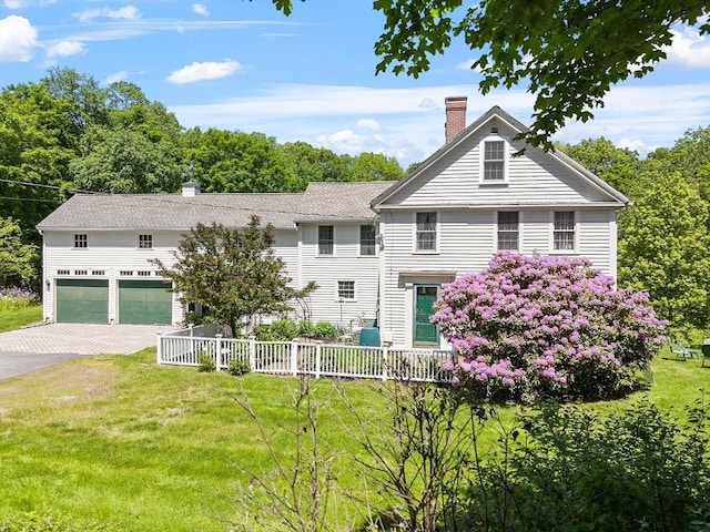 34 Fletcher Ln, Littleton, MA 01460 - view of front of home featuring a chimney, a garage, and driveway