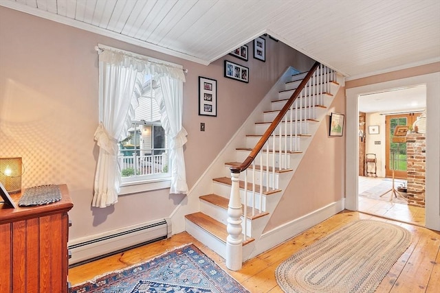 34 Fletcher Ln, Littleton, MA 01460 - staircase featuring a baseboard heating unit, wood-type flooring, crown molding, and baseboards
