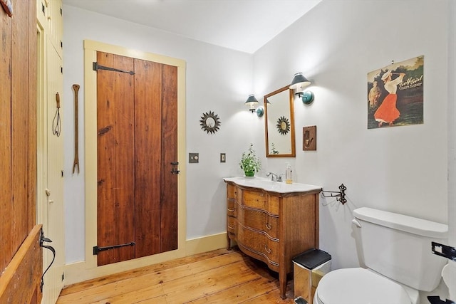 34 Fletcher Ln, Littleton, MA 01460 - bathroom with vanity, wood-type flooring, toilet, and baseboards