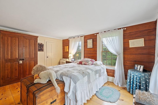 34 Fletcher Ln, Littleton, MA 01460 - bedroom featuring light wood-style floors, ornamental molding, and wood walls