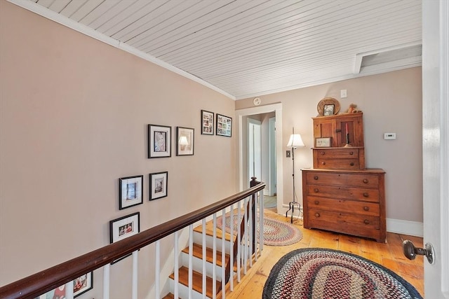34 Fletcher Ln, Littleton, MA 01460 - corridor with light wood finished floors, an upstairs landing, crown molding, wood ceiling, and baseboards