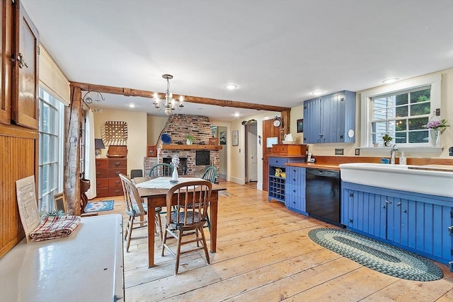 34 Fletcher Ln, Littleton, MA 01460 - kitchen featuring blue cabinetry, dishwasher, light wood-style floors, a chandelier, and decorative light fixtures