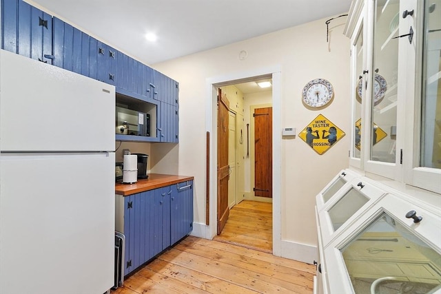 34 Fletcher Ln, Littleton, MA 01460 - kitchen with freestanding refrigerator, blue cabinetry, light wood finished floors, butcher block countertops, and black microwave