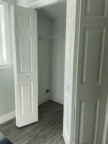 clothes washing area with hardwood / wood-style flooring