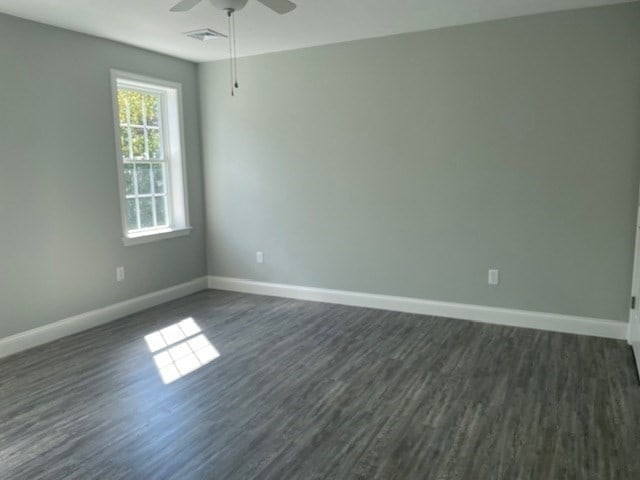 empty room featuring ceiling fan and dark hardwood / wood-style floors