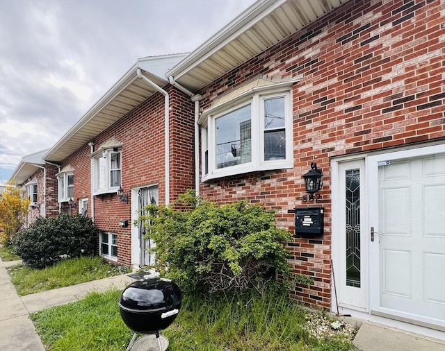 view of property exterior with brick siding