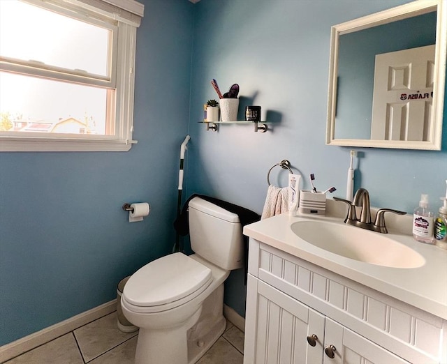 bathroom featuring vanity, tile patterned flooring, toilet, and baseboards