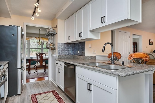 kitchen featuring light wood-type flooring, appliances with stainless steel finishes, sink, and white cabinets