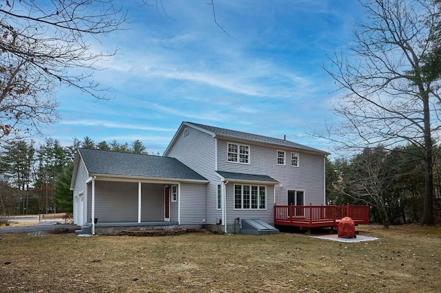 back of house featuring a wooden deck and a lawn