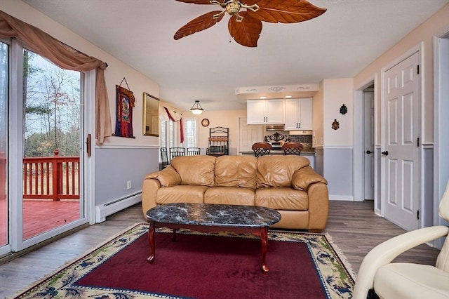 living room with ceiling fan, a baseboard radiator, and hardwood / wood-style floors