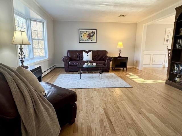 living room featuring visible vents, crown molding, baseboard heating, and wood finished floors