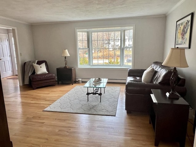 living area featuring a textured ceiling, ornamental molding, light wood-type flooring, and a baseboard radiator