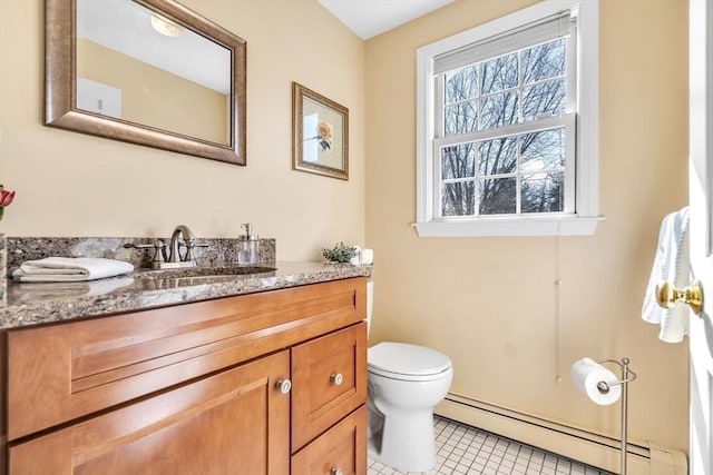 bathroom featuring tile patterned flooring, toilet, vanity, and baseboard heating