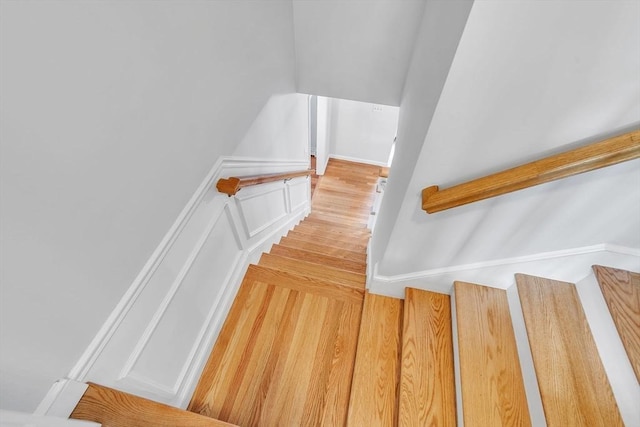 stairway featuring wood finished floors