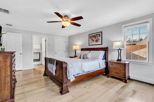 bedroom with ornamental molding, light wood-style flooring, visible vents, and baseboards