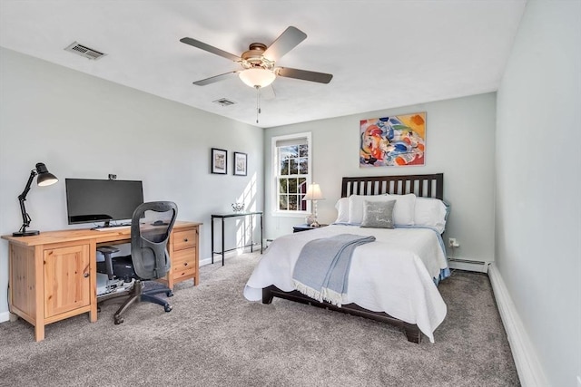 carpeted bedroom with baseboard heating, visible vents, and baseboards