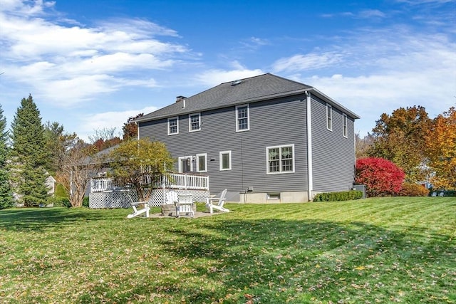 back of house featuring a yard and a deck