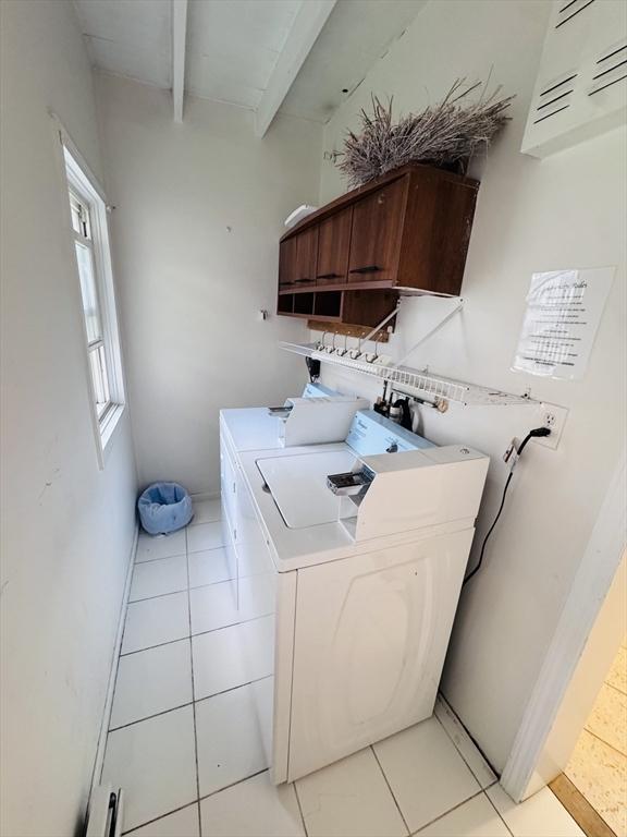 27 Shelby St, Worcester, MA 01605 - laundry area with separate washer and dryer, cabinet space, and light tile patterned flooring