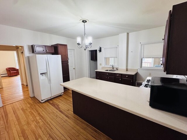 27 Shelby St, Worcester, MA 01605 - kitchen featuring white fridge with ice dispenser, a peninsula, light wood-type flooring, a chandelier, and light countertops