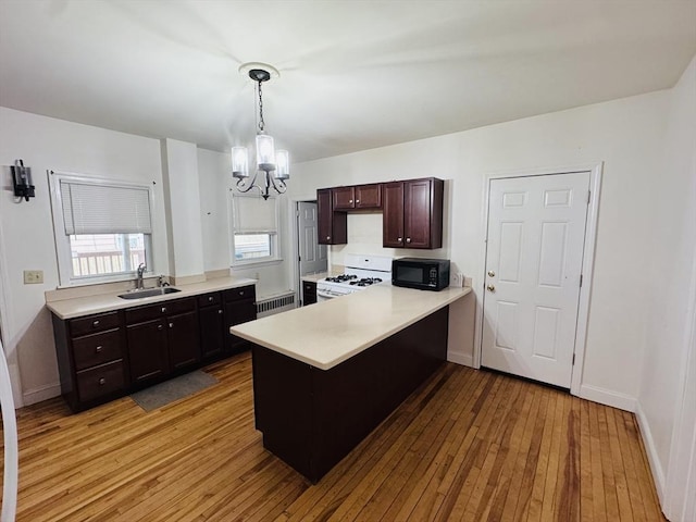 27 Shelby St, Worcester, MA 01605 - kitchen featuring white gas stove, a chandelier, black microwave, light wood-style floors, and light countertops