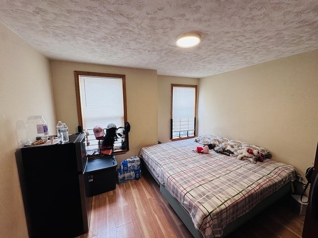 27 Shelby St, Worcester, MA 01605 - bedroom with wood finished floors and a textured ceiling