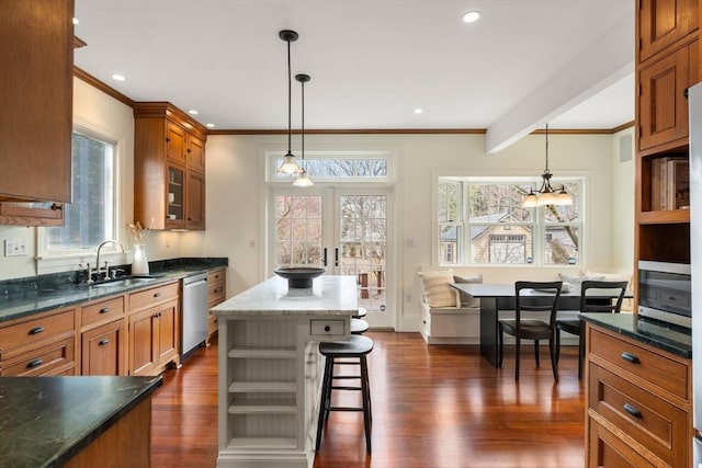 kitchen with brown cabinetry, a kitchen island, open shelves, a sink, and dishwasher