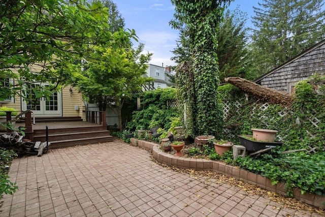 view of patio / terrace with french doors, a deck, and fence