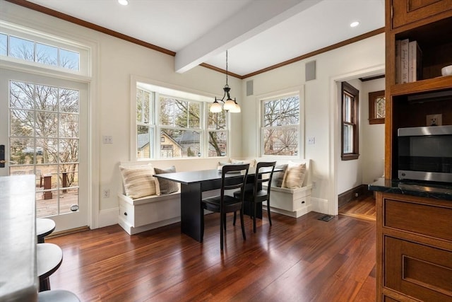 dining room with baseboards, beam ceiling, dark wood-style flooring, crown molding, and breakfast area