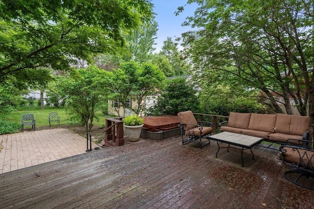 deck featuring outdoor lounge area and a lawn