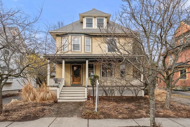 american foursquare style home featuring a porch