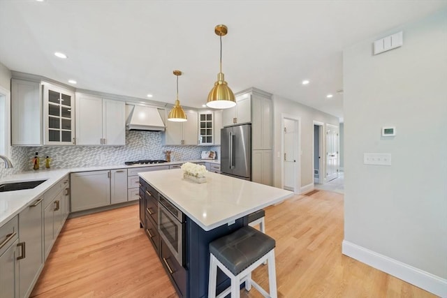 43 Lake Ave, Sharon, MA 02067 - kitchen featuring custom range hood, appliances with stainless steel finishes, backsplash, a breakfast bar, and a center island