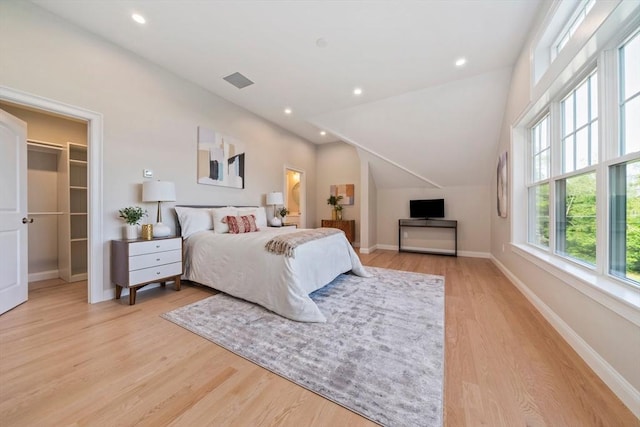43 Lake Ave, Sharon, MA 02067 - bedroom featuring a spacious closet, light wood-type flooring, vaulted ceiling, and recessed lighting