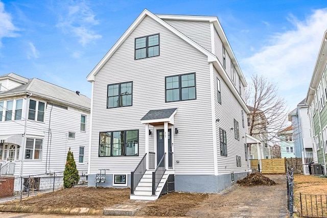 view of front of home featuring fence and central AC unit