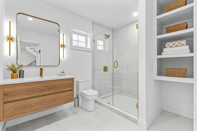 bathroom with a stall shower, baseboards, toilet, vanity, and built in shelves