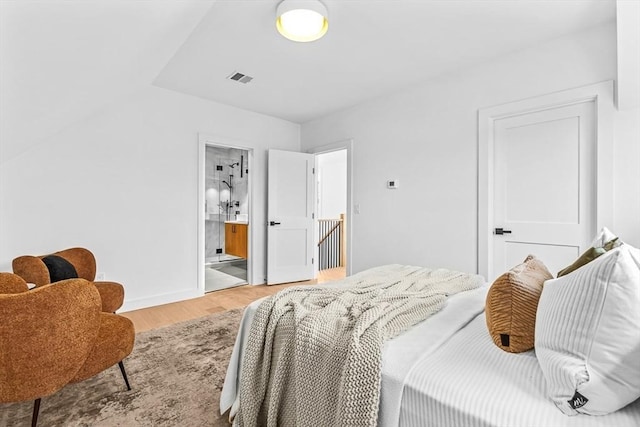 bedroom with light wood-type flooring, baseboards, and visible vents