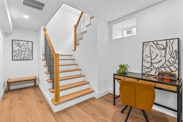 stairs with baseboards, visible vents, wood finished floors, and recessed lighting