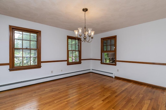 10 Whipple Rd, Hamilton, MA 01982 - empty room with a chandelier, wood finished floors, plenty of natural light, and baseboards