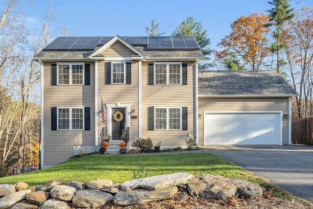 261 Bean Porridge Hill Rd, Westminster, MA 01473 - colonial-style house featuring roof mounted solar panels, a front yard, an attached garage, and aphalt driveway