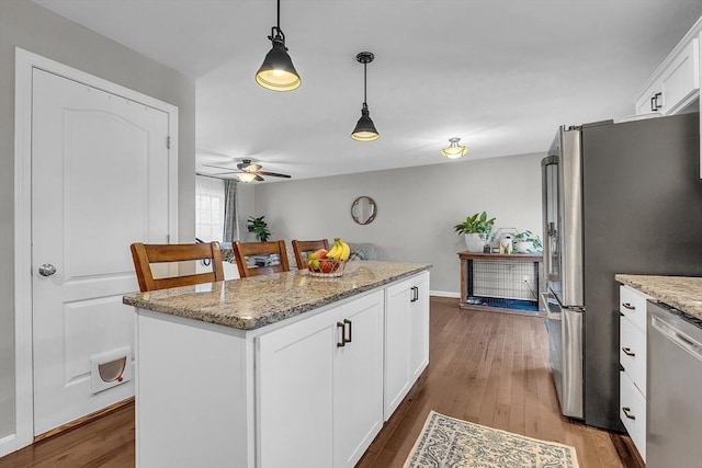 261 Bean Porridge Hill Rd, Westminster, MA 01473 - kitchen featuring white cabinets, hardwood / wood-style flooring, a ceiling fan, appliances with stainless steel finishes, and pendant lighting