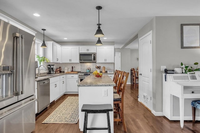 261 Bean Porridge Hill Rd, Westminster, MA 01473 - kitchen featuring tasteful backsplash, white cabinetry, a sink, premium appliances, and light stone counters
