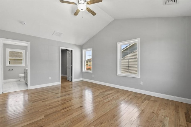 119 Tripp St, Fall River, MA 02724 - unfurnished bedroom with light wood-style flooring, lofted ceiling, a walk in closet, ensuite bathroom, and a ceiling fan