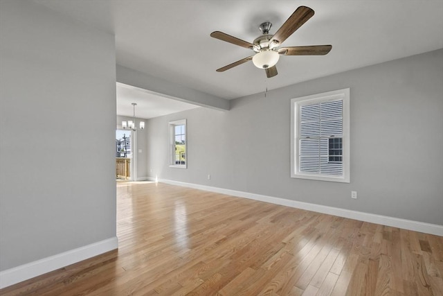 119 Tripp St, Fall River, MA 02724 - empty room featuring ceiling fan, light wood-style flooring, and a chandelier