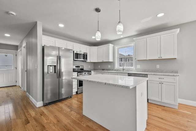 119 Tripp St, Fall River, MA 02724 - kitchen with appliances with stainless steel finishes, white cabinets, light wood-type flooring, and recessed lighting